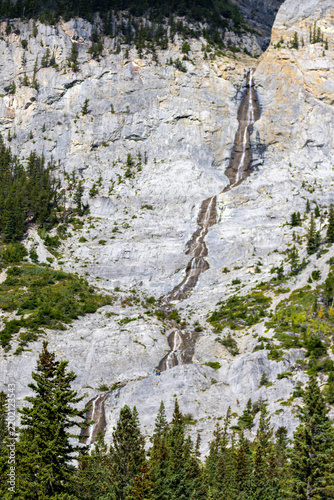 Rock Climbers climbing Cascade Mountain near Lake Minnewanka near Banff, Canada