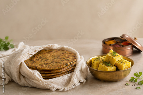 Wrapped thepla and dhokla with spice box, Indian food tradition concept