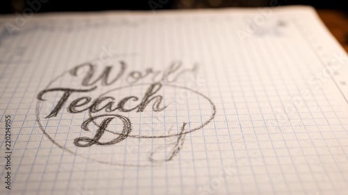 Close-up of a pencil sketch on graph paper, showing a calligraphic design for 'World Teach Day' with elegant lettering and a circular frame.