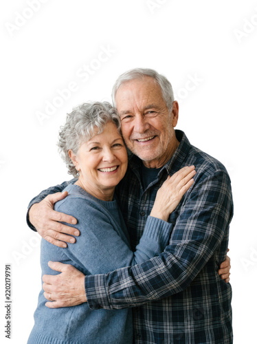 An elderly couple embraces warmly. The man, with gray hair and a smiling face, holds his wife close.