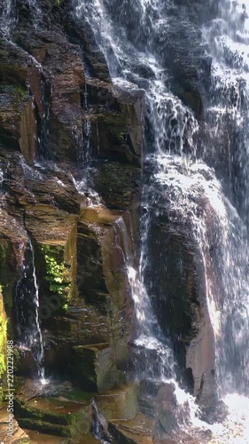 Water Streaming Down Dark Wet Rock Vertical Video