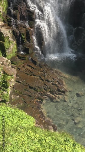 Backlit Waterfall Falling Down Rock Face Vertical Video