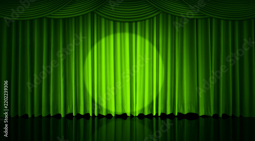 A green curtain hung on the theater stage, with spotlights shining on it.