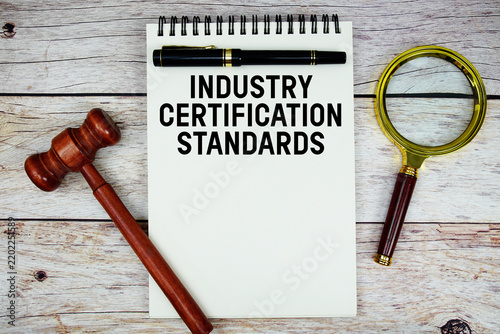 фотографія Industry Certification Standards text written on notepad with wooden judge gavel