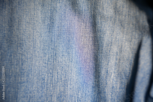 An image of a fabric background, woven using an old machine-based system; denim