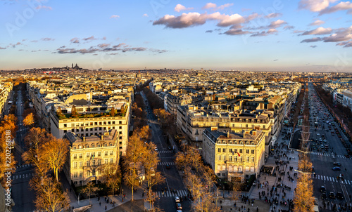 Canvastavla Panoramic aerial view of Paris cityscape and Champs-Elysees avenue during golden hour sunset with Sacre-Coeur basilica in the background, France