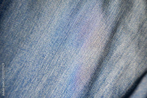 An image of a fabric background, woven using an old machine-based system; denim