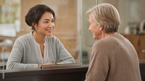 Credit union teller helping member at window