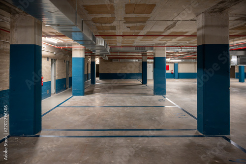 Empty underground parking garage with concrete pillars
