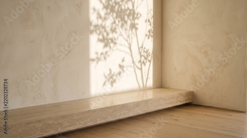 Minimalist travertine display shelf with tree shadow on a textured beige wall