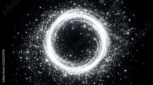 A circular, glowing, white light with a black background, emitting a sparkly effect.