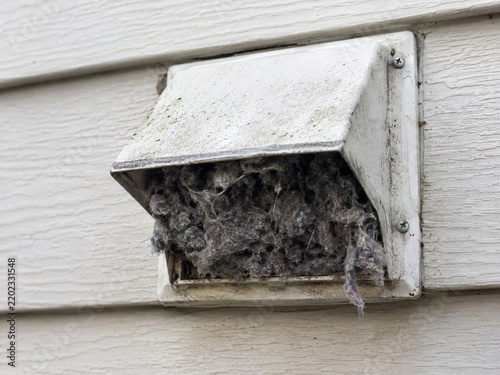 Exterior dryer vent hood clogged with heavy lint buildup