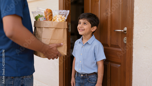 Happy Indian Boy Receiving Grocery Delivery Bag at Front Door of House