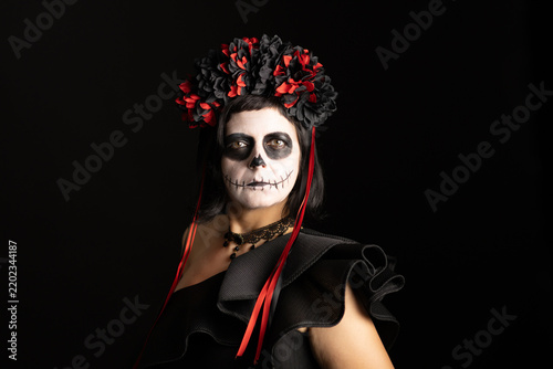 Canvastavla Day of the Dead or Halloween themed image with a woman with skull painting on her face and a skull