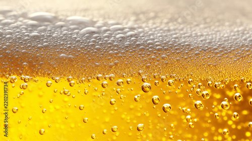 Close-up of golden beer with creamy foam and sparkling bubbles