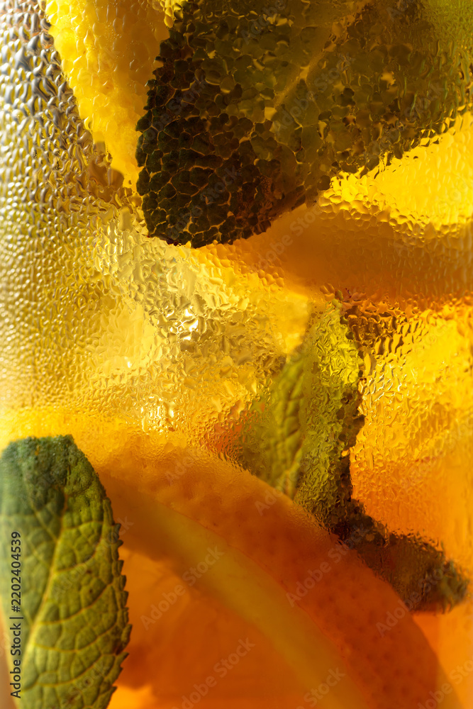 Fototapeta premium Iced tea in a misted glass. Macro shot.