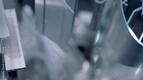 Samples of new aluminum industrial profiles of varying shapes and design complexity are presented at the exhibition. Closeup. Shot in motion