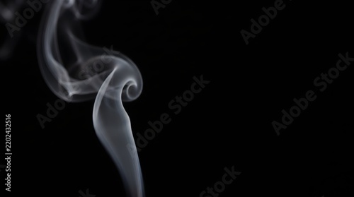 Soft Delicate White Smoke Curl Rising Against Deep Black Dark Background