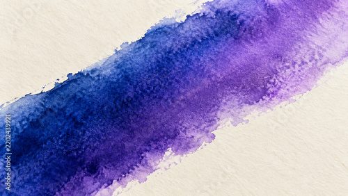 Abstract blue and purple watercolor brush stroke on textured paper
