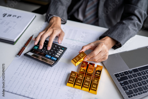Gold Trading Investment Concept with Businessman Offering Gold for Mining Company Investment and Stock Market Trading