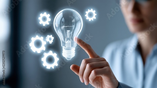 A person touching a glowing lightbulb surrounded by cogs, symbolizing innovation and new ideas