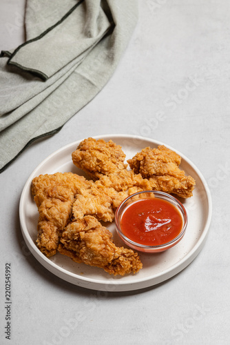 Fried Chicken with Sauce on Neutral Background