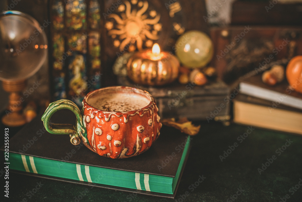 Obraz premium Cozy autumn reading scene with open book, warm coffee and subtle magical atmosphere