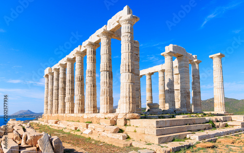 Temple of Poseidon at Cape Sounion against blue sky and sea in Greece