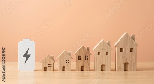 Home Battery Storage and Renewable Energy Concept with Wooden Houses and Electricity Icon for Residential Power Efficiency