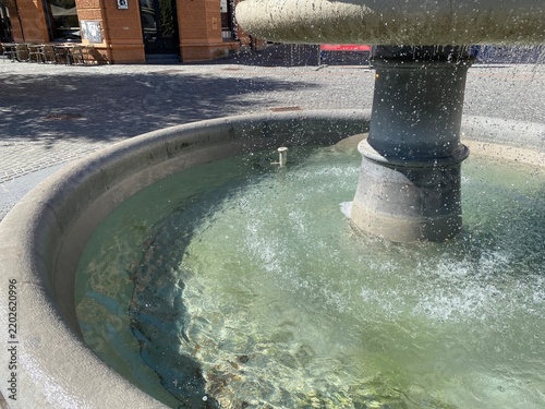 Water fountain close up against a blue sky on a sunny day