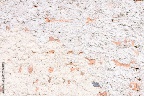 Textured white plaster wall background with peeling stucco