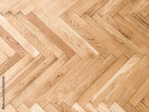 High angle background texture of wooden herringbone parquet flooring