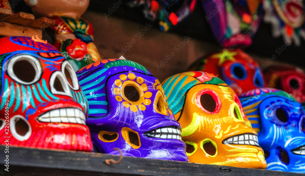 Fototapeta premium Colorfully painted skulls (Calaveras), used during the Day of the Dead celebrations, are seen sold on the market in Mexico City.