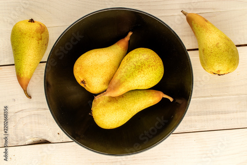 Ripe sweet pears on a wooden table, macro shot. Top view.