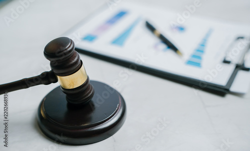 Wooden gavel financial chart ink pen legal document business analysis courtroom justice professional serious reliable