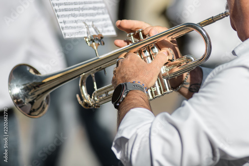 Close-Up of Musician Playing Silver Trumpet with Sheet Music