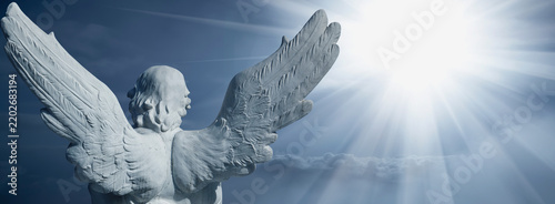 Obraz na plátně Guardian angel facing the radiant light of heaven, symbolic image of hope, faith, salvation and the journey of the soul toward eternity
