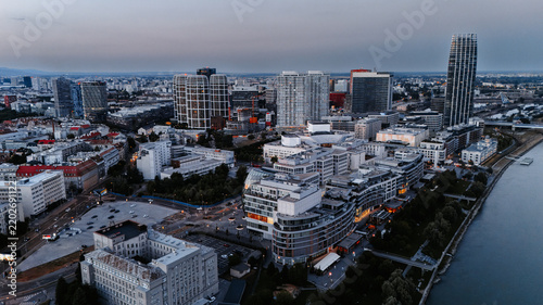 Konstfotografi Downtown blocks and glass towers beside a riverside promenade
