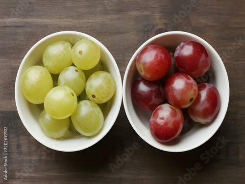 Fresh green and red grapes in white bowls on rustic wooden table for food photography and branding