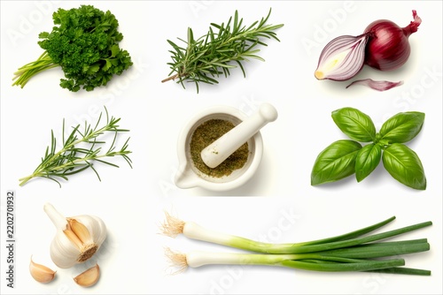 Collection of fresh culinary herbs and vegetables arranged on white background