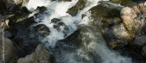Obraz na plátně Whitewater rushing over dark rocks in a mountain stream, Yunnan