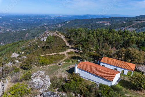An elevated view captures white chapels with orange tile roofs