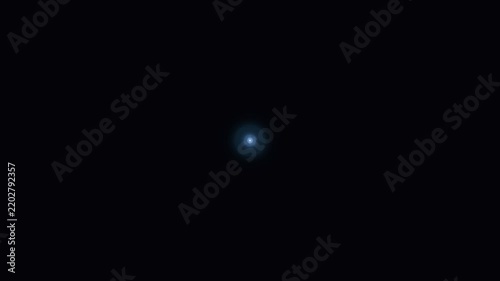 Glowing blue light point shines brilliantly in the center of complete darkness.