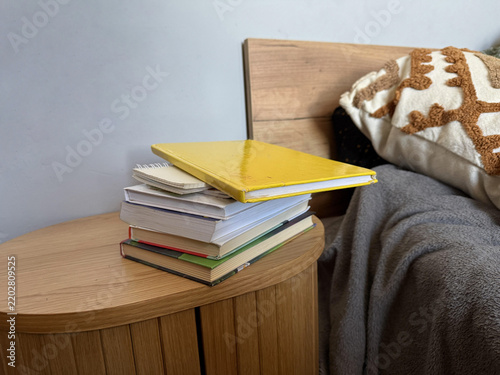 a bed with a pile of books on it