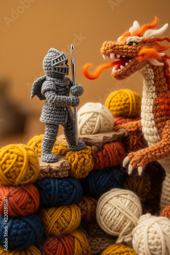 A miniature knitted knight made bravely facing a fluffy knitted dragon