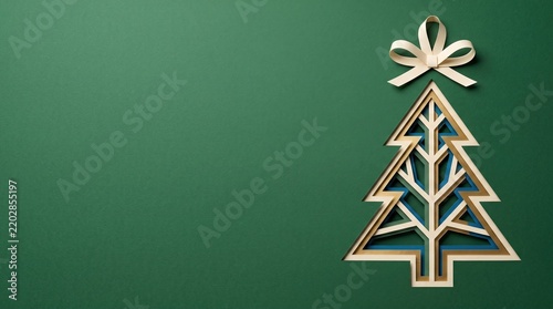 Wooden Christmas tree cutout with beige bow against dark green backdrop