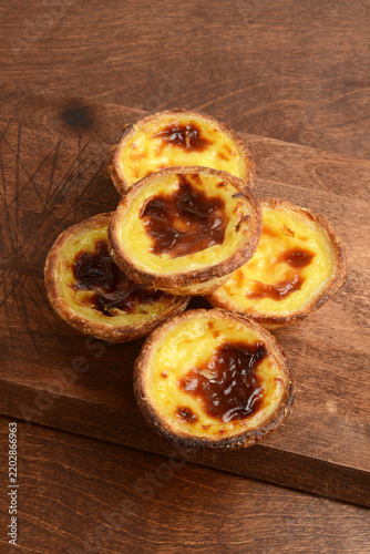 top view pile Portuguese Custard Tarts on cutting board