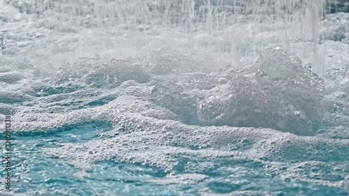 A close up of a pool with a waterfall flowing into it