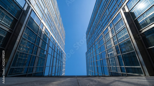 Twin glass towers converge skyward in a symmetric downtown urban geometric abstraction