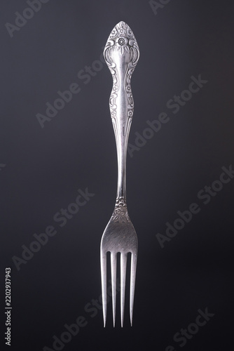 Silver fork close up  on a black background